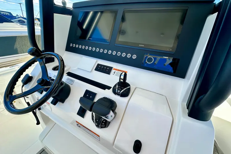 Slide: The Image of 2026 Regulator 31 boat dashboard with dual screens and steering wheel. - 12