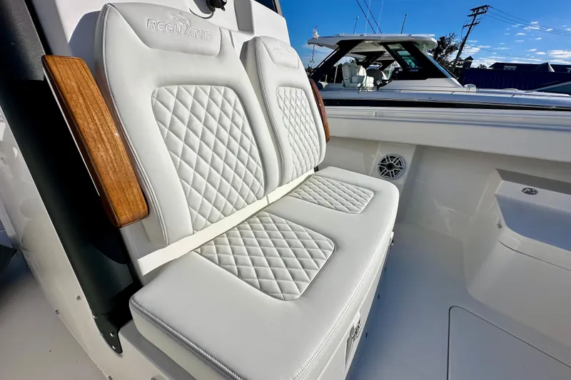 Slide: The Image of Luxurious seating on 2026 Regulator 31 boat with quilted upholstery and wooden accents. - 21