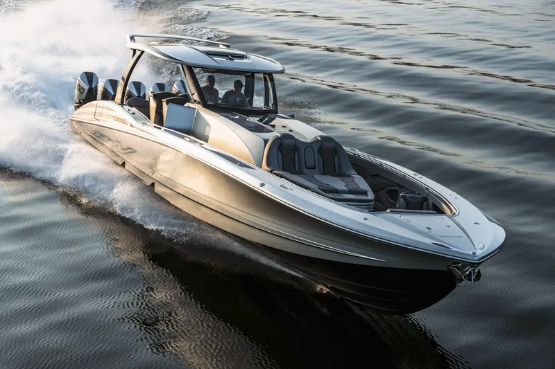 Slide: The Image of 2024 MTI 50v boat with multiple engines on a trailer outside a garage. - 2