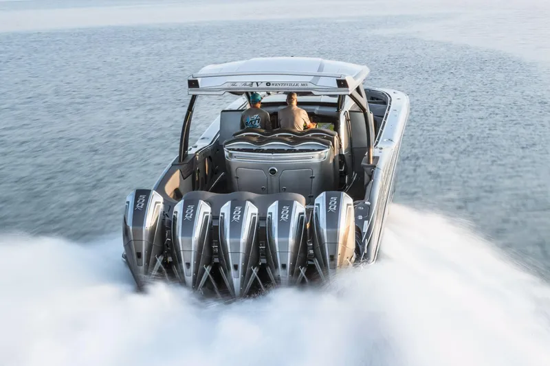 Slide: The Image of 2024 MTI 50v boat cruising on a serene lake at sunset. - 3