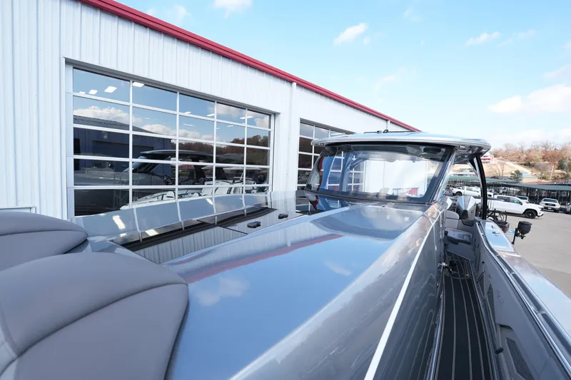 Slide: The Image of 2024 MTI 50v boat beside a modern building with large windows. - 46