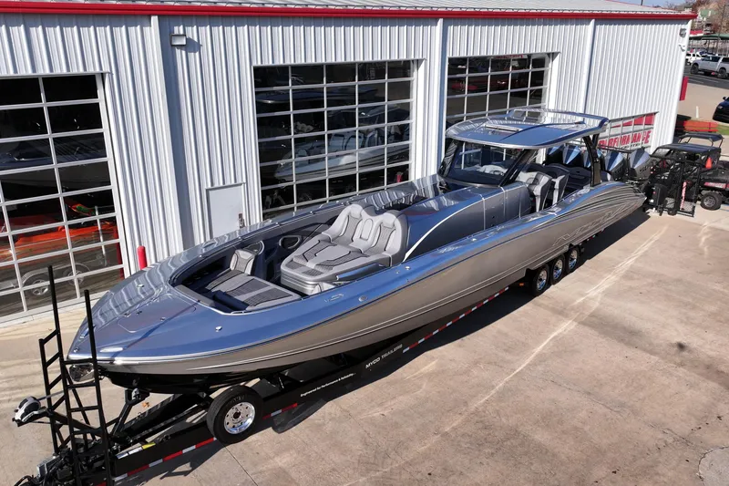 Slide: The Image of 2024 MTI 50v luxury boat on trailer outside a showroom. - 56
