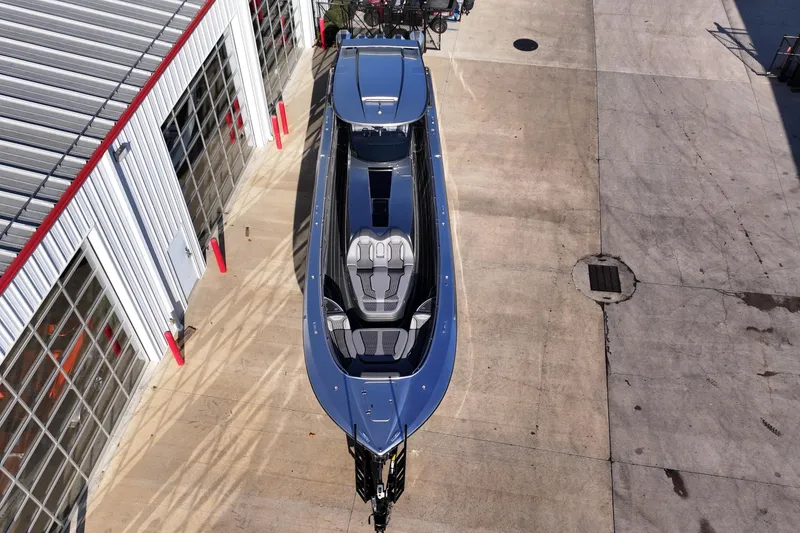 Slide: The Image of Aerial view of a 2024 MTI 50v boat parked near a building. - 58