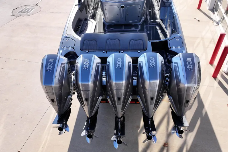 Slide: The Image of 2024 MTI 50v boat with four powerful 500R outboard engines, docked on concrete. - 65
