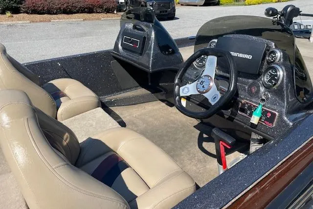 Slide: The Image of 2015 Bass Cat Pantera II boat interior with steering wheel and beige seats. - 3