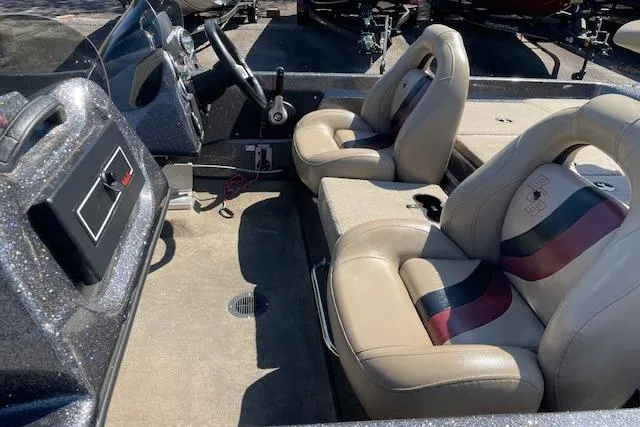 Slide: The Image of 2015 Bass Cat Pantera II boat interior with beige and striped seats, steering wheel, and dashboard. - 5