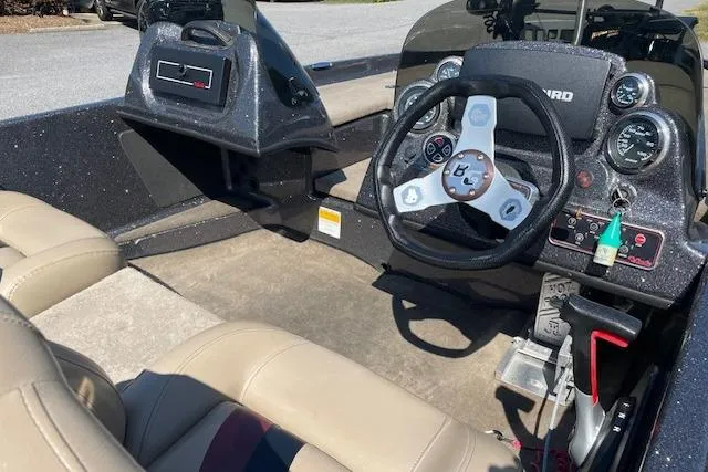 Slide: The Image of 2015 Bass Cat Pantera II boat interior with steering wheel and dashboard controls. - 7