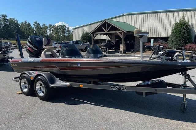 Slide: The Image of 2015 Bass Cat Pantera II boat on trailer, parked outdoors near a building. - 8