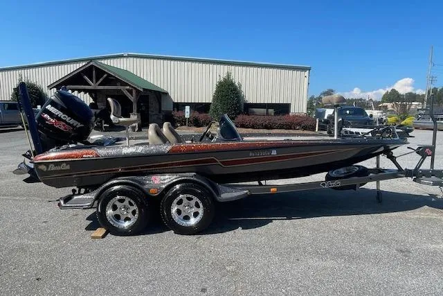 Slide: The Image of 2015 Bass Cat Pantera II boat with trailer, parked outdoors on a sunny day. - 9