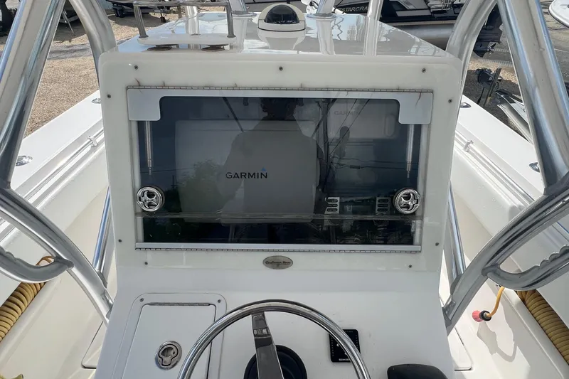 Slide: The Image of 2012 SeaHunter 29 boat console with Garmin navigation system and steering wheel. - 11
