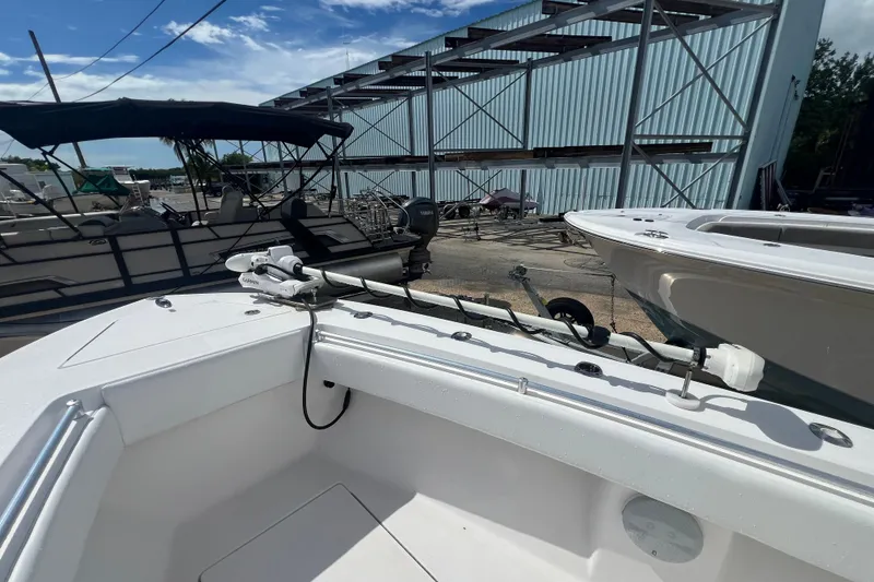 Slide: The Image of 2012 SeaHunter 29 boat docked, featuring a spacious deck and modern equipment. - 14