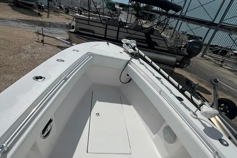 Slide: The Image of 2012 SeaHunter 29 boat interior with fishing rod holders and storage compartment. - 18