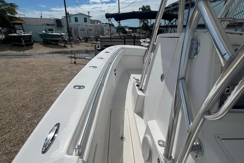 Slide: The Image of 2012 SeaHunter 29 boat deck with stainless steel railings, docked in a marina. - 20