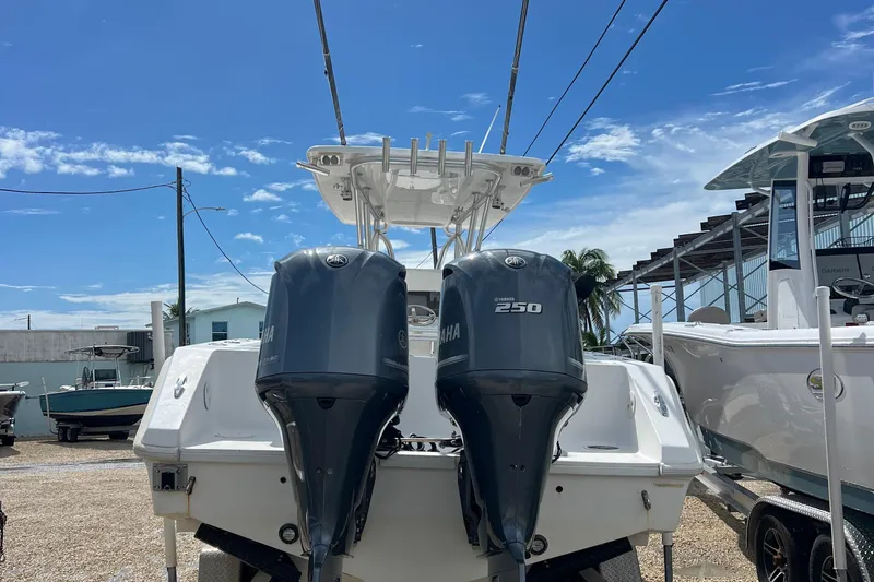 Slide: The Image of 2012 SeaHunter 29 boat with dual Yamaha 250 engines, parked under a clear blue sky. - 5