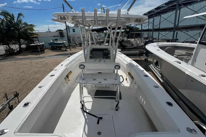 Slide: The Image of 2012 SeaHunter 29 boat with center console and T-top in a marina setting. - 7