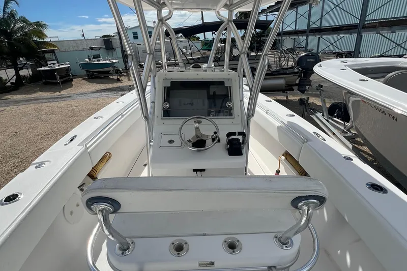 Slide: The Image of 2012 SeaHunter 29 boat interior with steering console and seating, docked in a marina. - 9