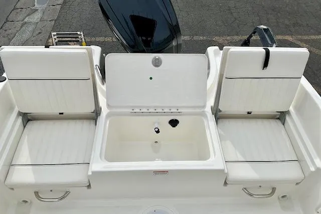 Slide: The Image of 2025 Bayliner Trophy T18 boat seating and storage area, featuring white cushioned seats. - 14
