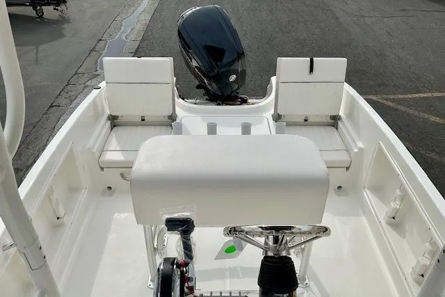 Slide: The Image of 2025 Bayliner Trophy T18 boat interior with seating and outboard motor. - 17