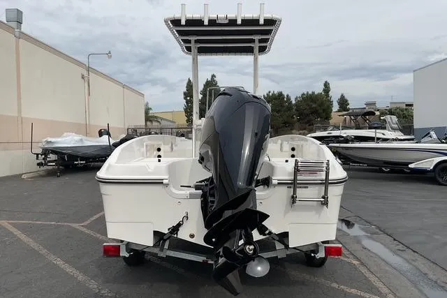 Slide: The Image of 2025 Bayliner Trophy T18 boat with outboard motor, parked in a marina. - 4