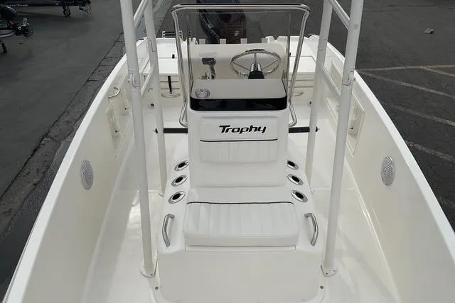 Slide: The Image of 2025 Bayliner Trophy T18 boat interior with steering console and seating. - 9