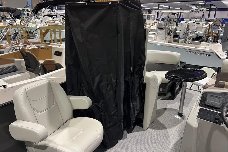 Slide: The Image of 2026 Sylvan Mirage 820 CLZ DH boat interior with seating and table at a boat show. - 14