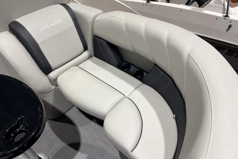 Slide: The Image of Luxurious seating on 2026 Sylvan Mirage 820 CLZ DH boat, featuring elegant upholstery and cup holders. - 21