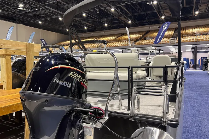 Slide: The Image of 2026 Sylvan Mirage 820 CLZ DH pontoon boat with Yamaha engine at indoor exhibition. - 3