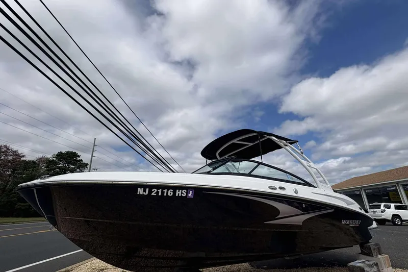 The Image of 2023 Monterey M-22 boat on display under a partly cloudy sky. - 1
