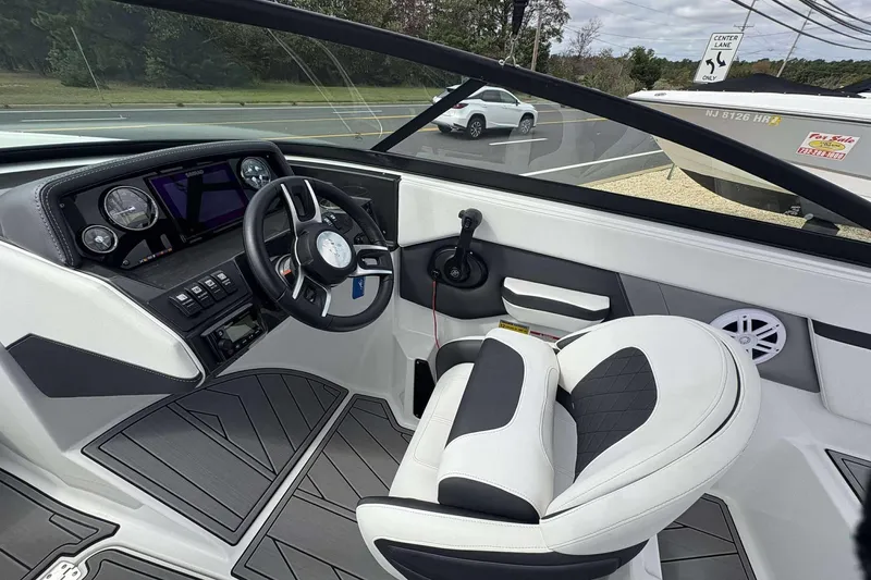 Slide: The Image of Interior of a 2023 Monterey M-22 boat, featuring a sleek dashboard and comfortable seating. - 14