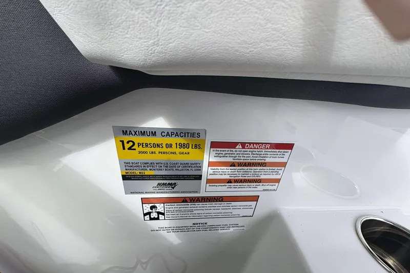 Slide: The Image of Capacity warning label on 2023 Monterey M-22 boat, maximum 12 persons or 1980 lbs. - 15