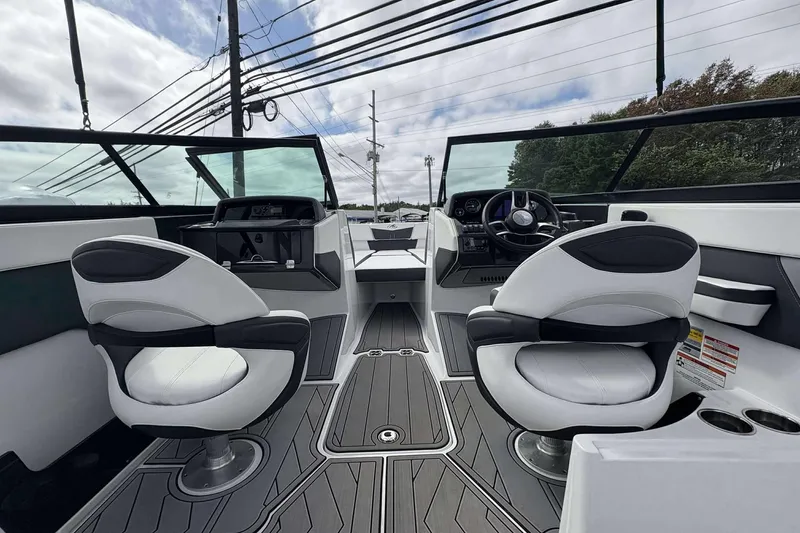 Slide: The Image of 2023 Monterey M-22 boat interior with modern dashboard and dual captain chairs. - 18