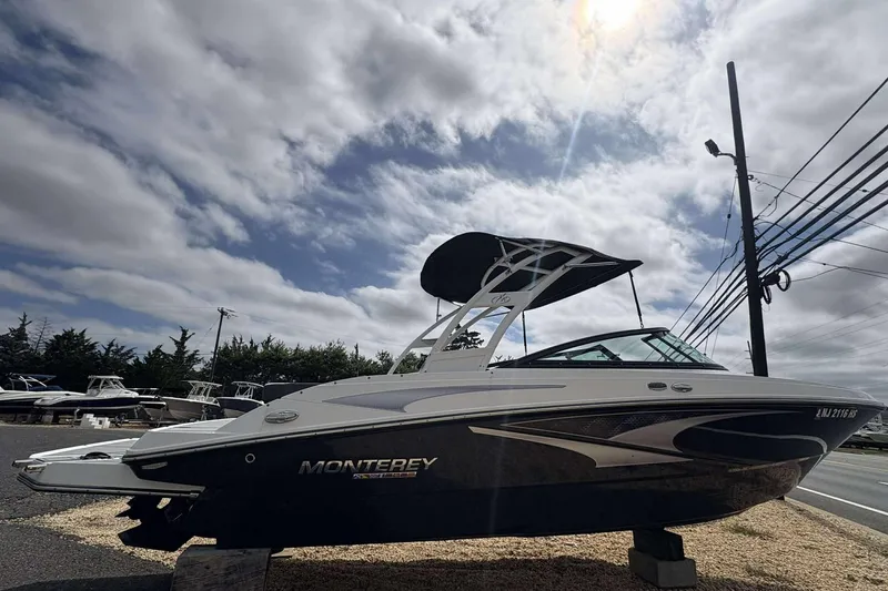 Slide: The Image of 2023 Monterey M-22 boat displayed outdoors under a cloudy sky. - 3