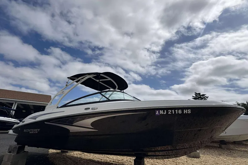Slide: The Image of 2023 Monterey M-22 boat with sleek design under a partly cloudy sky. - 4