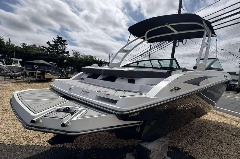 Slide: The Image of 2023 Monterey M-22 boat with sleek design, displayed outdoors under cloudy sky. - 7