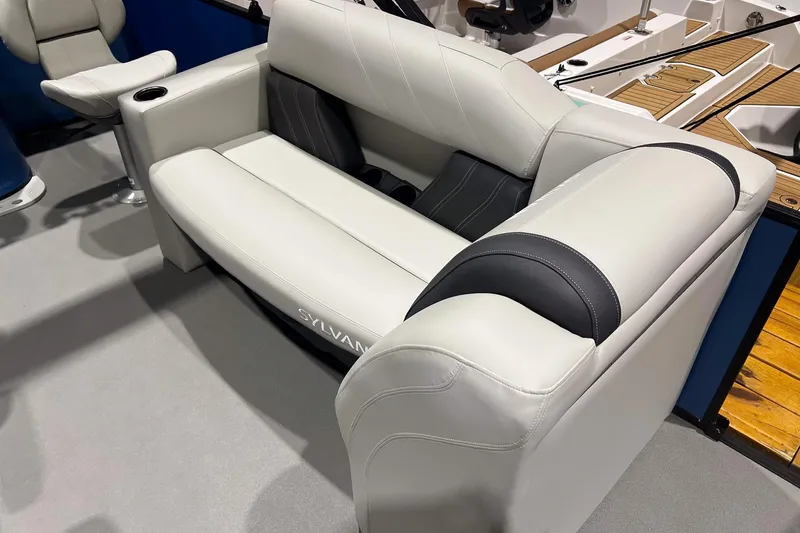 Slide: The Image of 2026 Sylvan Mirage Fish 820 Party Fish boat seating, featuring luxurious white and black upholstery. - 10