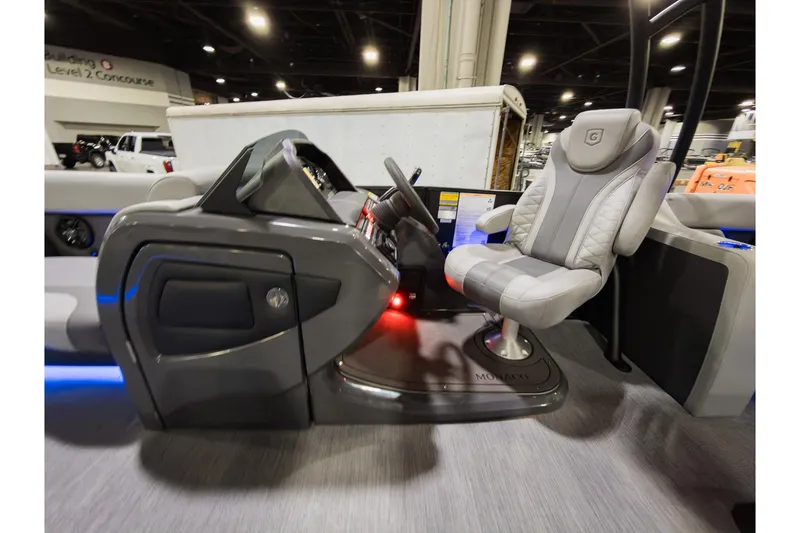 Slide: The Image of 2026 Godfrey Monaco 235 Sun Deck interior with captain's chair and control console. - 12