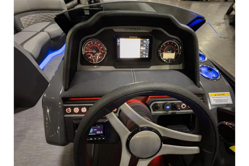 Slide: The Image of 2026 Godfrey Monaco 235 Sun Deck dashboard with modern controls and illuminated gauges. - 15