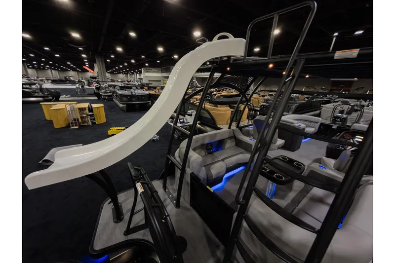 Slide: The Image of 2026 Godfrey Monaco 235 Sun Deck boat with slide, showcased indoors. - 22