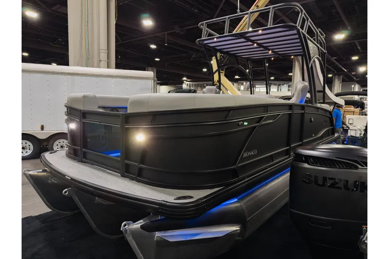 Slide: The Image of 2026 Godfrey Monaco 235 Sun Deck boat displayed indoors with modern design features. - 3