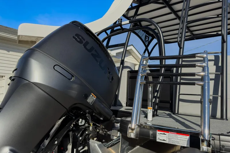Slide: The Image of 2026 Godfrey Monaco 235 Sun Deck with Suzuki outboard motor and stainless steel ladder. - 30