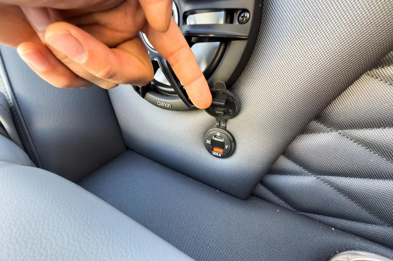 Slide: The Image of Hand interacting with USB port on 2026 Godfrey Monaco 235 Sun Deck boat interior. - 41