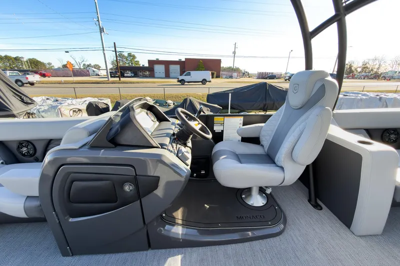 Slide: The Image of 2026 Godfrey Monaco 235 Sun Deck boat interior with captain's chair and control panel. - 45