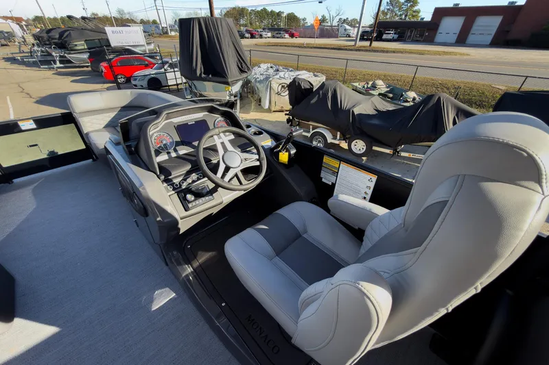 Slide: The Image of Helm of 2026 Godfrey Monaco 235 Sun Deck boat with modern controls and seating. - 48