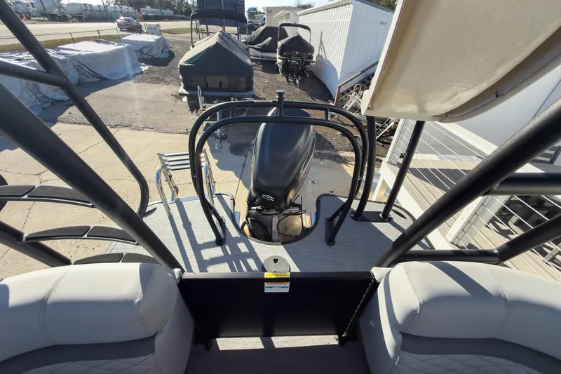 Slide: The Image of 2026 Godfrey Monaco 235 Sun Deck boat with outboard motor and seating area. - 61