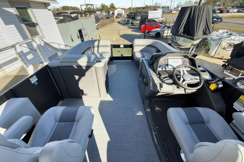 Slide: The Image of 2026 Godfrey Monaco 235 Sun Deck boat interior with modern seating and steering console. - 74