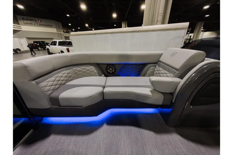 Slide: The Image of Luxurious seating on 2026 Godfrey Monaco 235 Sun Deck boat with ambient blue lighting. - 8