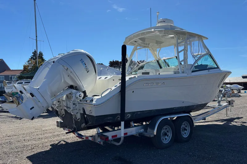 Slide: The Image of 2024 Cobia 280 Dual Console boat on trailer with Yamaha outboard engines. - 18