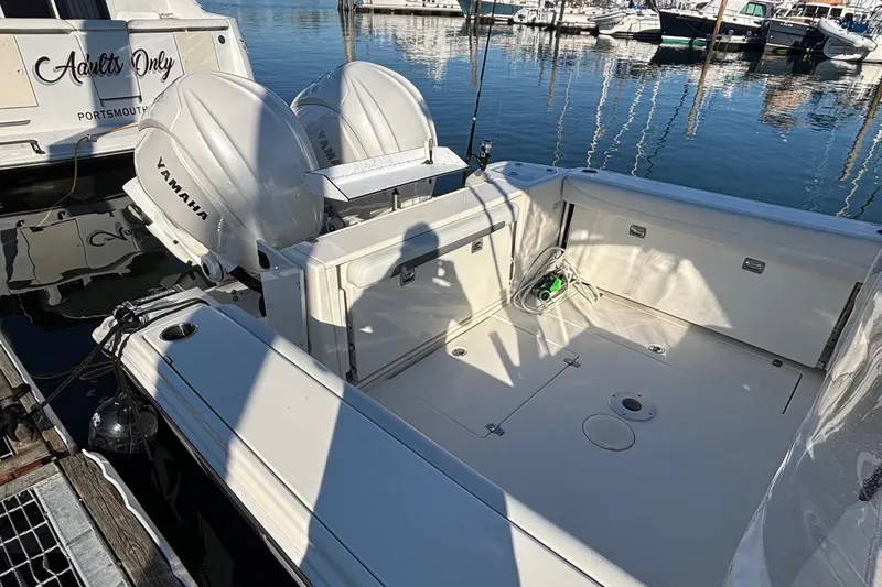 Slide: The Image of 2024 Cobia 280 Dual Console boat with Yamaha engines docked at marina. - 5