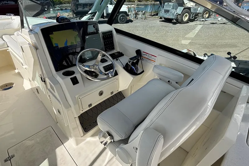 Slide: The Image of 2024 Cobia 280 Dual Console helm with modern controls and navigation display. - 8