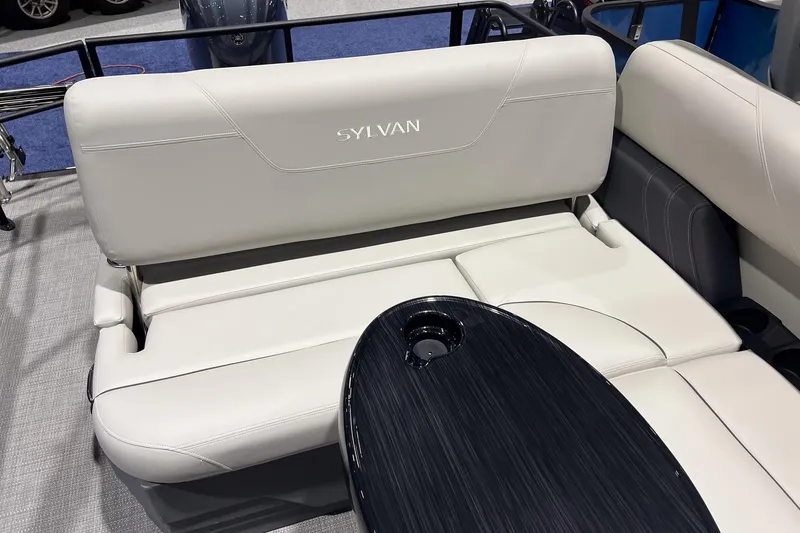 Slide: The Image of 2026 Sylvan Mirage 822 CLZ boat interior with sleek seating and modern table design. - 10